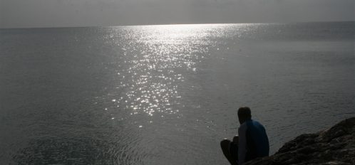 man and the sun overlooking the ocean in Eleuthera