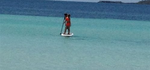 woman paddleboarding in the ocean in Eleuthera